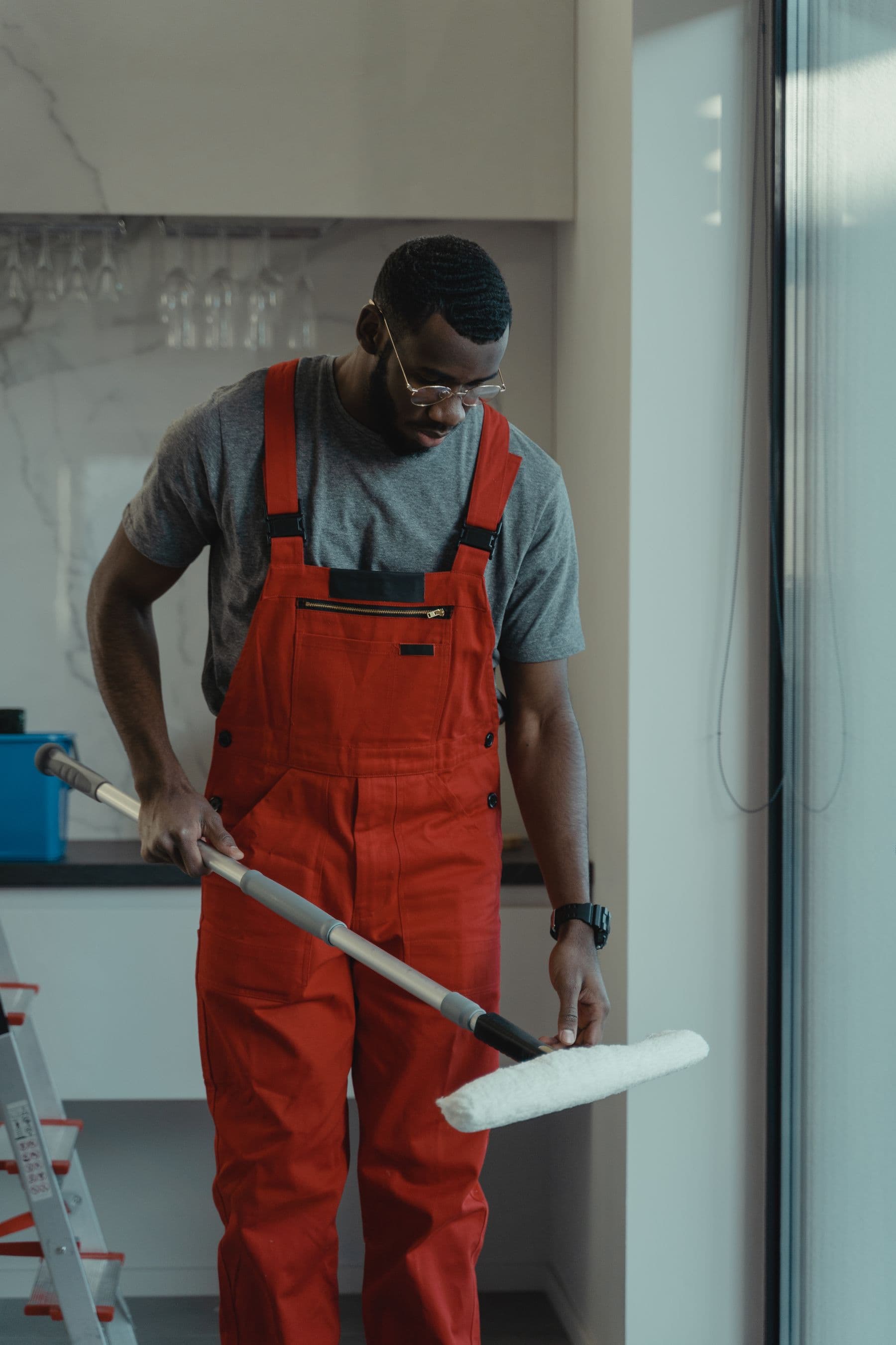 A cleaning operative working through a bright office interior.